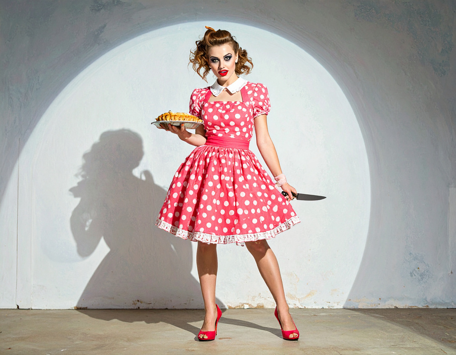 The Pie Killer under a spotlight, holding a pie and a knife